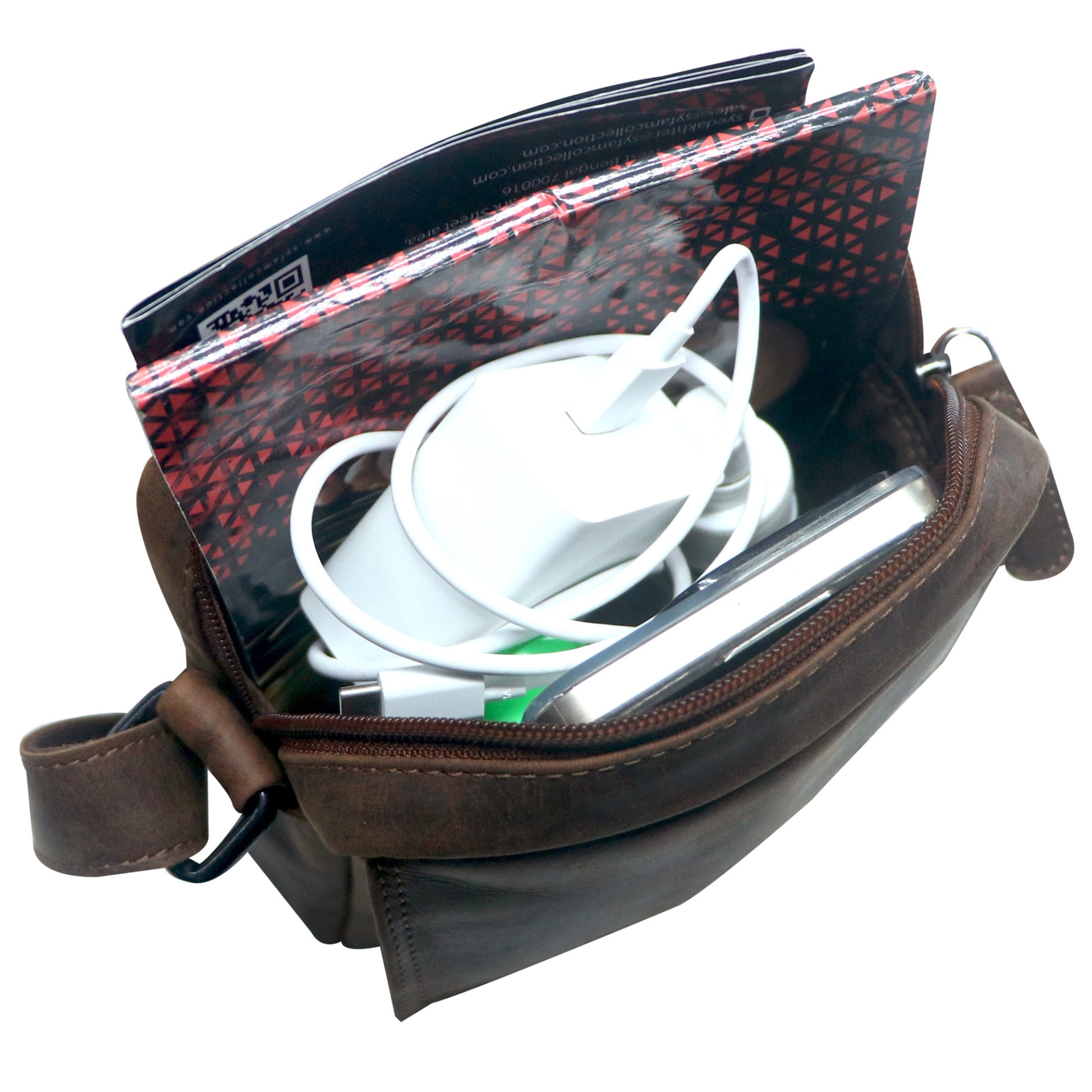 Brown leather bag with electronic devices inside on a white background