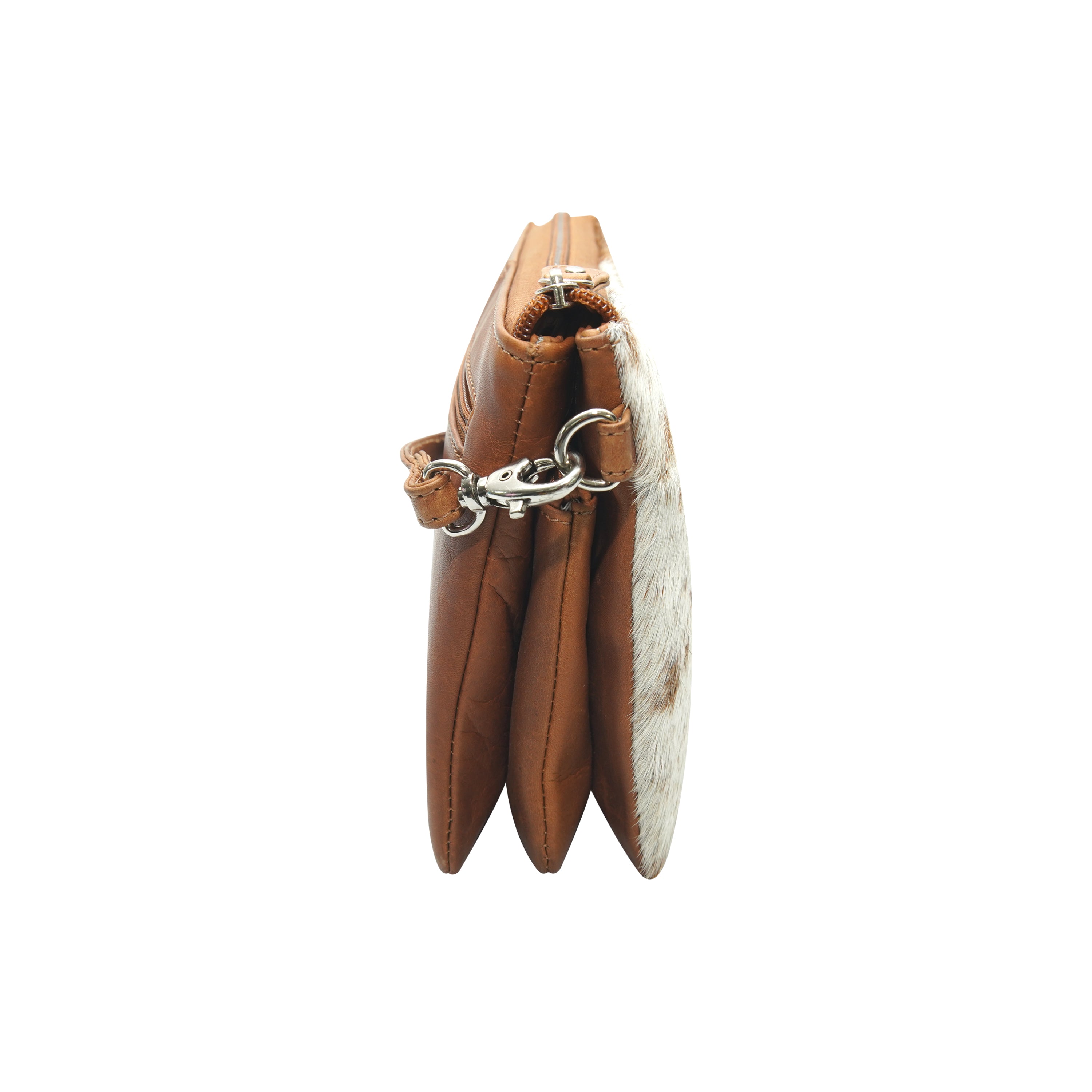 Side view of tan cowhide crossbody leather bag