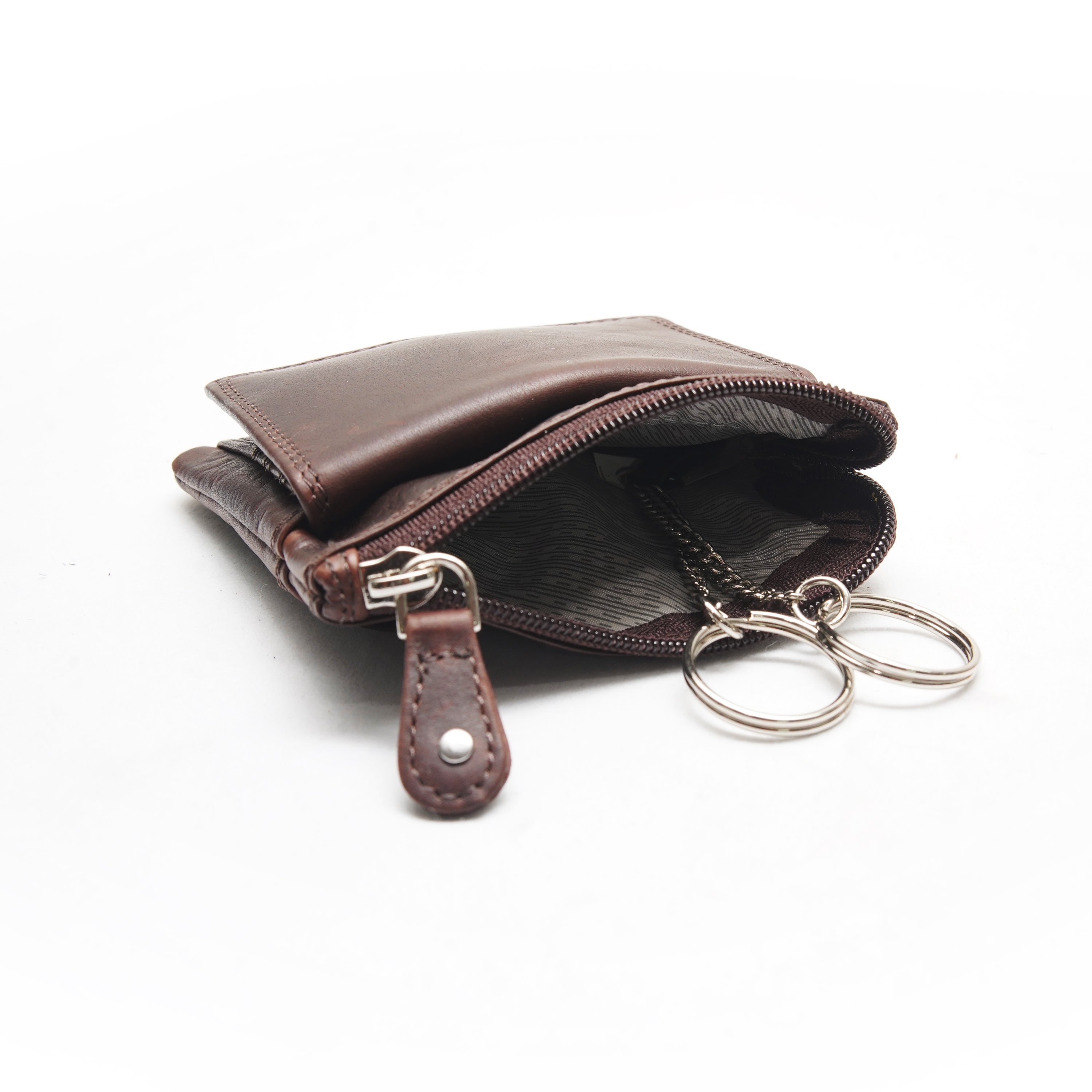 Brown leather keychain pouch with keys on a white background