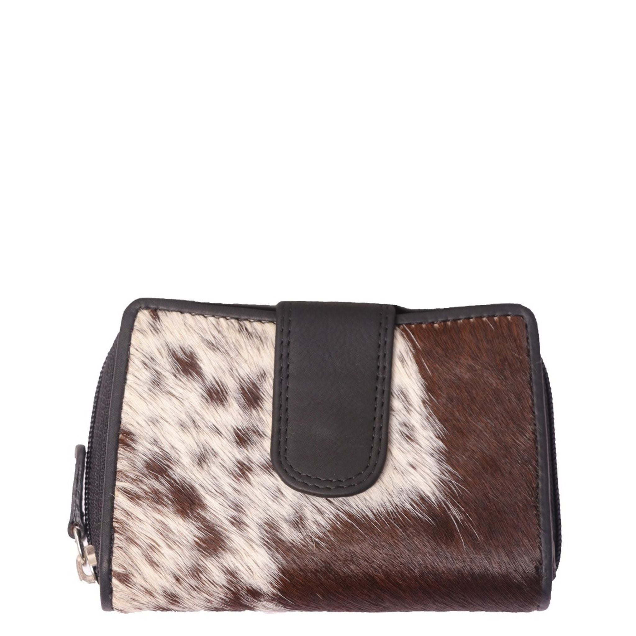 A hairon leather wallet featuring a mix of solid brown and patterned cowhide leather, with a flap closure.