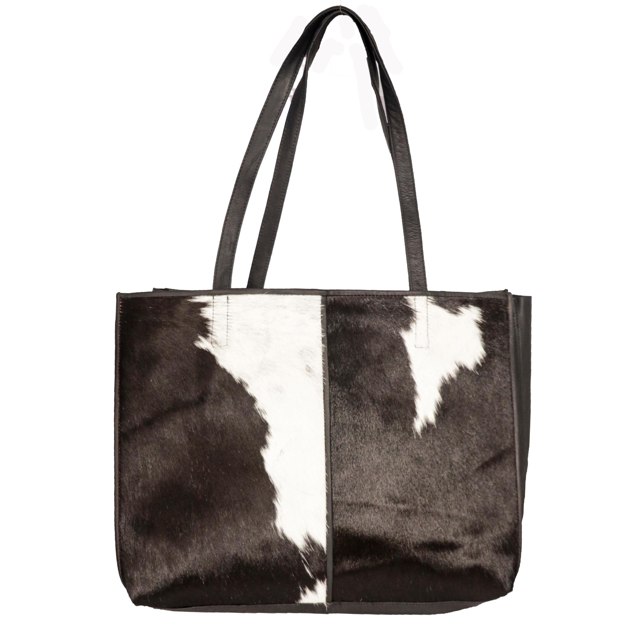 A large hairon shoulder bag with brown and white cowhide design, featuring two handles.